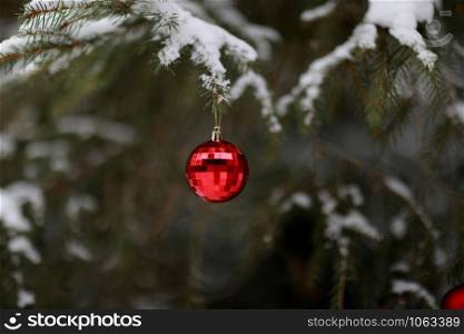 Christmas ball with a garland hanging on Christmas tree. Merry Christmas and Happy New Year. selective focus.. Christmas ball with a garland hanging on Christmas tree. Merry Christmas and Happy New Year. selective focus
