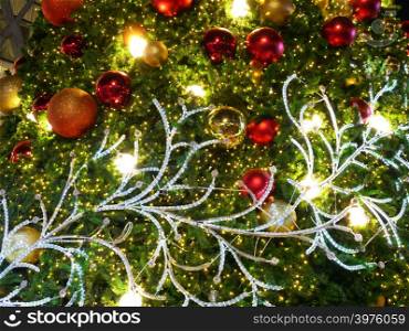 Christmas ball with in pine tree decoration with lights background.