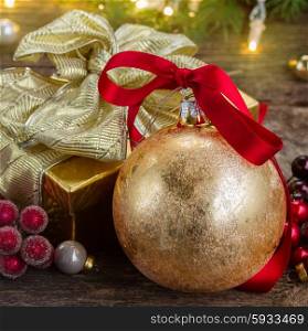 christmas ball with red bow and golden gift box . christmas ball with gift box