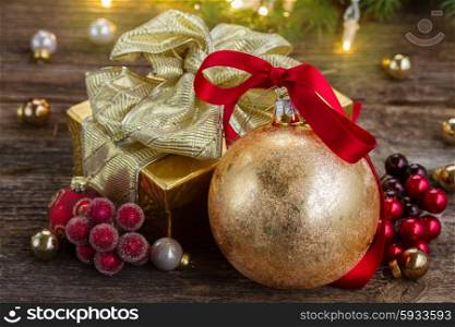 christmas ball with red bow and golden gift box . christmas ball with gift box