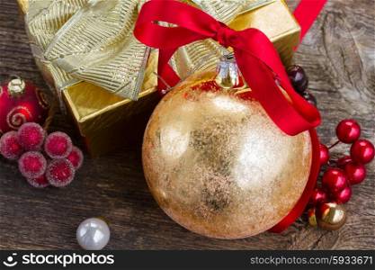 christmas ball with red ribbon and gift box . christmas ball with gift box