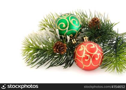 Christmas balls against the backdrop of tinsel with pine branches and cones