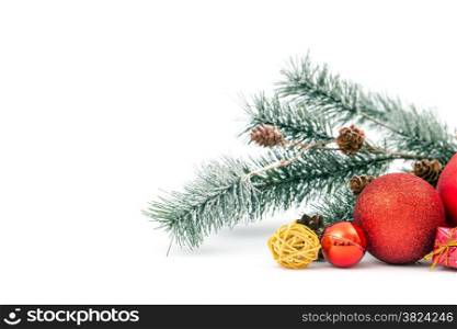 Christmas balls and fir branch on white background