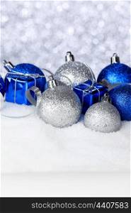 Christmas balls and gifts on snow