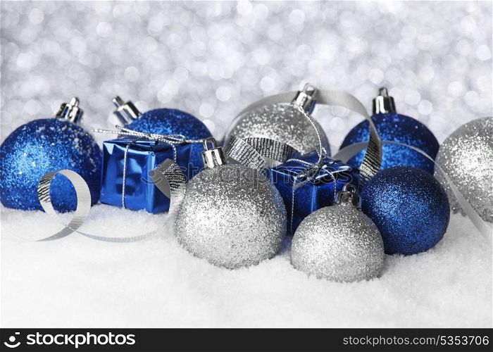 Christmas balls and gifts on snow