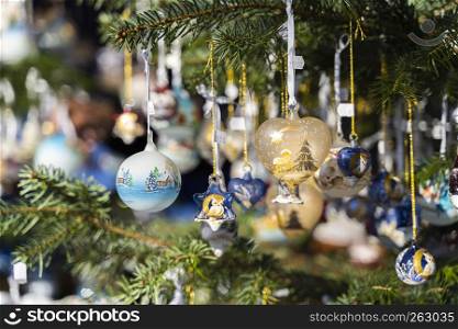 Christmas balls and other decoration on a christmas tree outdoors on the christmas market of meran, south tyrol