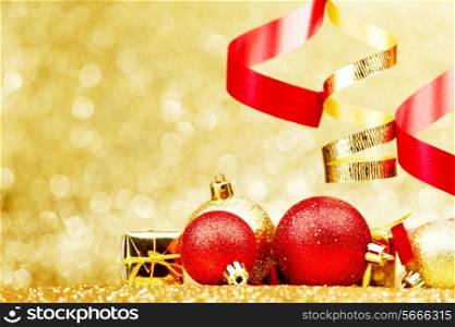 Christmas balls and ribbons on abstract glitter background