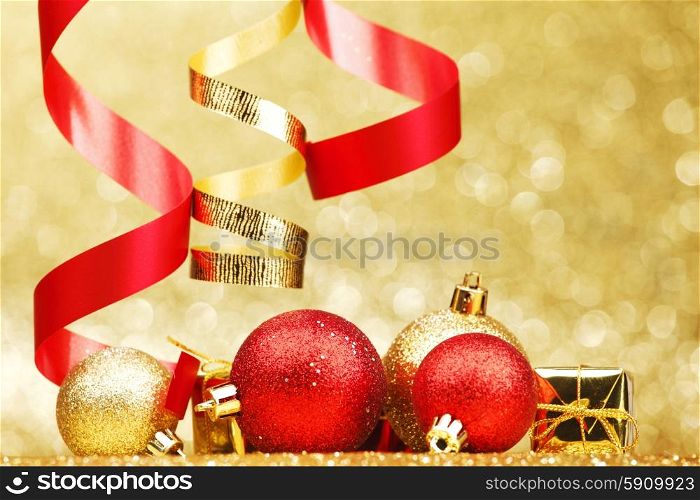Christmas balls and ribbons on abstract glitter background. Christmas balls and ribbons