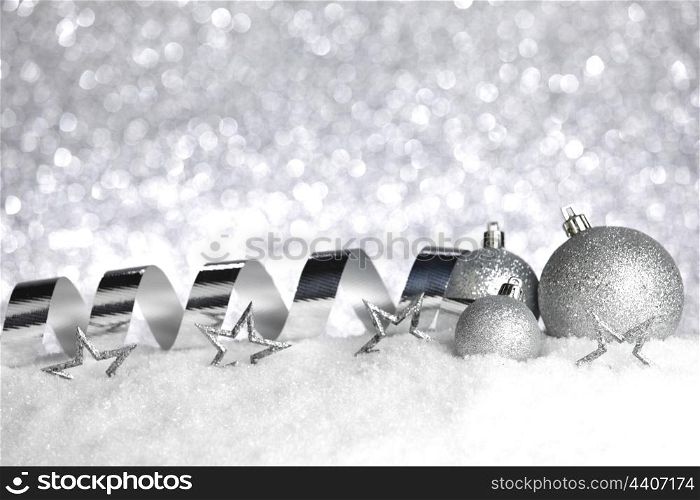 Christmas balls and ribbons on snow