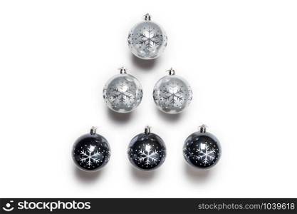 Christmas balls black and grey isolated on white, top view retro design, christmas decoration in a row background shape of a tree. Christmas balls black and grey isolated on white, top view retro design, christmas decoration in a row background