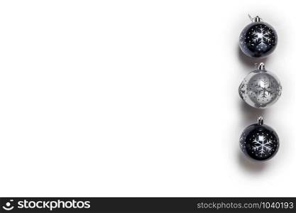 Christmas balls black and grey isolated on white, top view retro design, christmas decoration in a row background closeup. Christmas balls black and grey isolated on white, top view retro design, christmas decoration in a row background