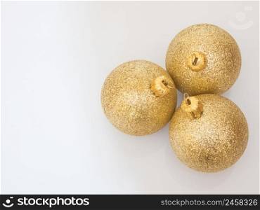 christmas balls gold color on a white background, top view. christmas decorations on white background