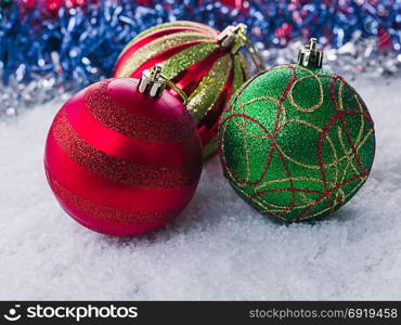 Christmas balls in the snow. Blurred Blue Background