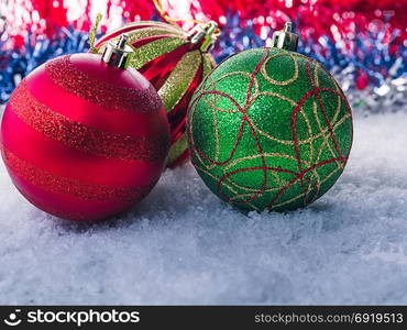 Christmas balls on a background of Christmas tree branches. Cold shade