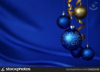 christmas balls on blue satin background
