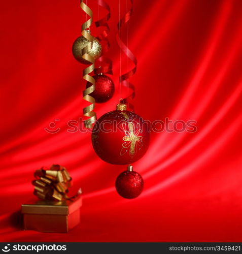 christmas balls on red satin background