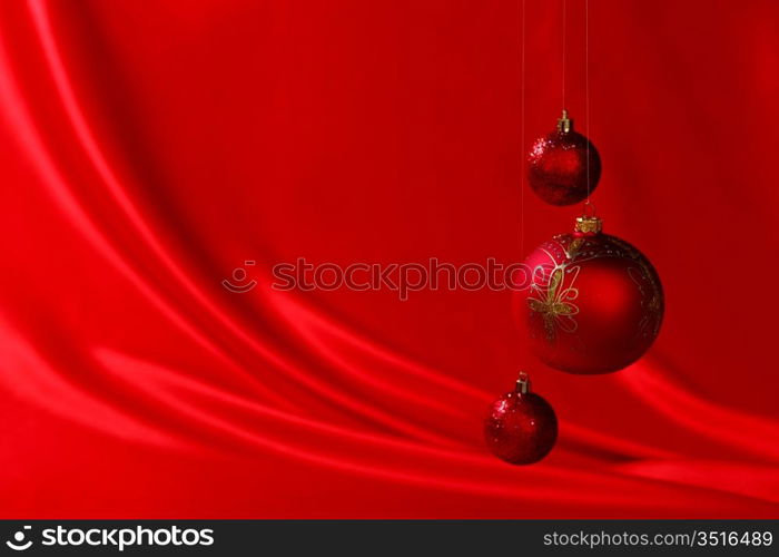 christmas balls on red satin background