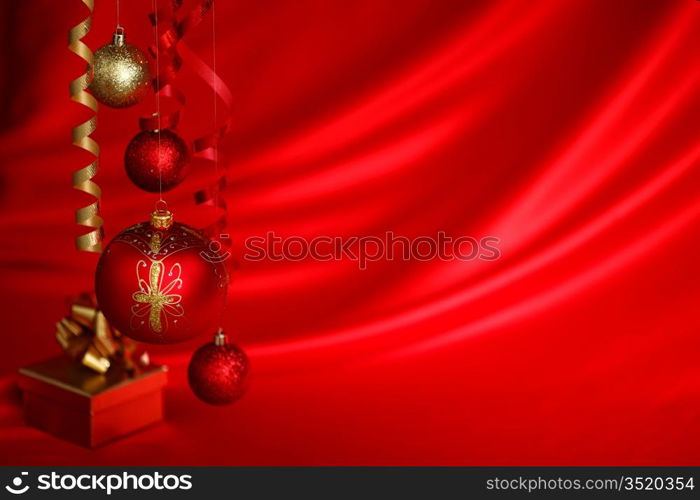 christmas balls on red satin background