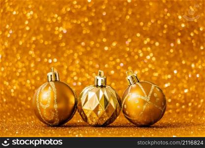 Christmas balls on shiny gold background. New Year concept for holiday card. Place for text.. Christmas balls on shiny gold background. New Year concept for holiday card.