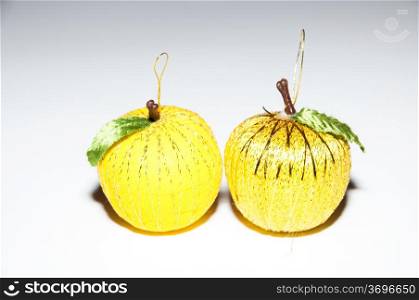 Christmas balls simulating a yellow colored fruit