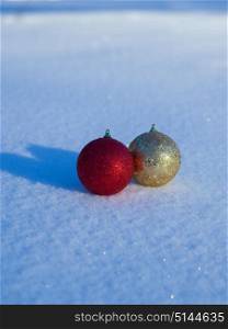 christmas balls tree decoration in fresh snow abstract background
