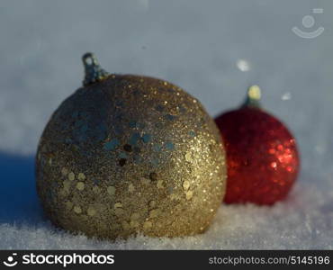 christmas balls tree decoration in fresh snow abstract background