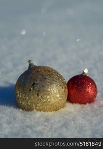 christmas balls tree decoration in fresh snow abstract background