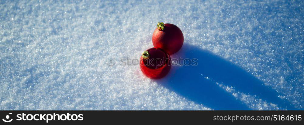 christmas balls tree decoration in fresh snow abstract background