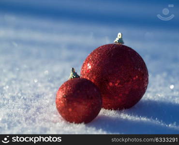 christmas balls tree decoration in fresh snow abstract background