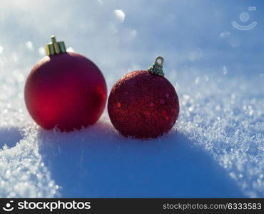 christmas balls tree decoration in fresh snow abstract background