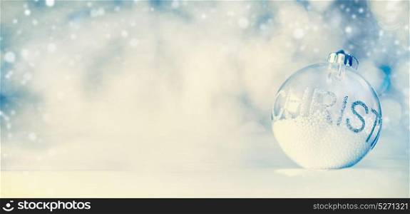 Christmas banner background with glass ball on blue winter bokeh background, front view