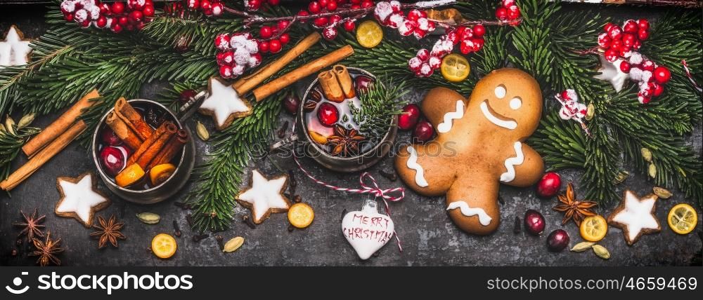 Christmas banner with gingerbread man , mug of mulled wine or punch, fir branches , holiday cookies and festive decoration and spices