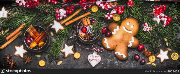 Christmas banner with gingerbread man , mug of mulled wine or punch, fir branches , holiday cookies and festive decoration and spices