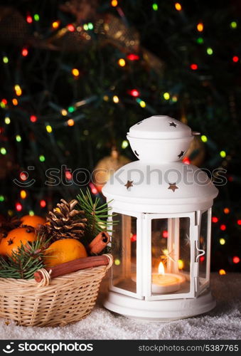 Christmas basket and candle lantern on the snow
