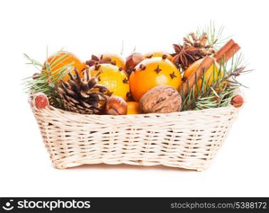 Christmas basket - fir, tangerins and spices isolated on white