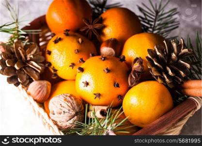Christmas basket - fir, tangerins and spices on the snow
