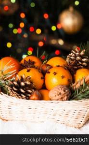 Christmas basket - fir, tangerins and spices on the snow