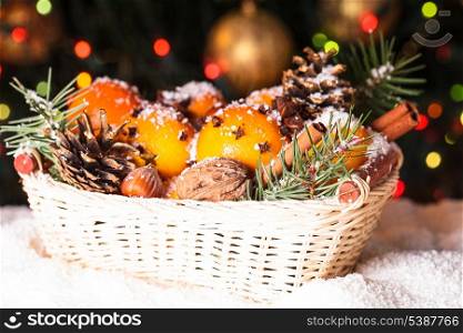 Christmas basket - fir, tangerins and spices under the snow