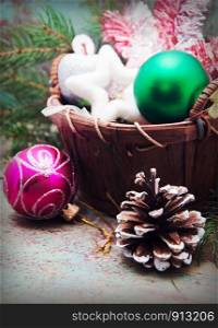 Christmas basket with toys on a wooden background