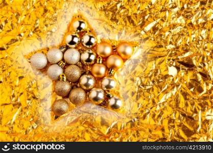 christmas baubles in star shape on golden background