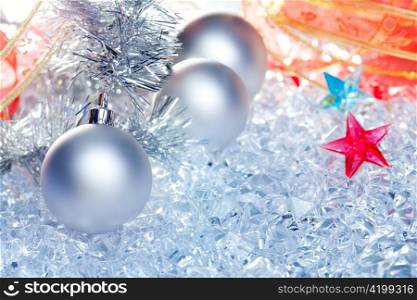 christmas baubles silver on winter ice with star symbol and ribbon