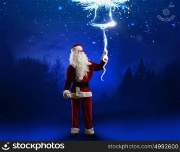 Christmas bell. Santa Claus ringing the Christmas bell. New Year eve