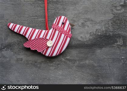 Christmas bird ornament on rustic style grunge background