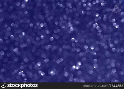 christmas blue background with with color of the year 2022 blue very peri bokeh light beams. christmas background