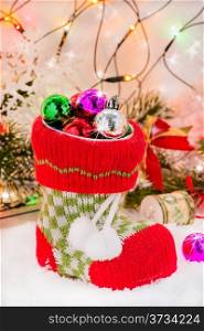 Christmas boot with decorations in festive lights and sparkles, selective focus