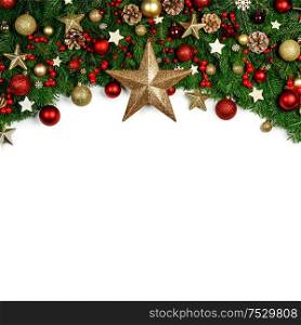 Christmas Border frame of tree branches around white background with copy space isolated, red and golden decor, berries, stars, cones. Christmas frame of tree branches