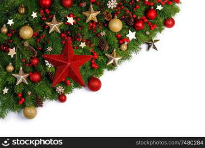 Christmas Border frame of tree branches on white background with copy space isolated, red and golden decor, berries, stars, cones. Christmas frame of tree branches