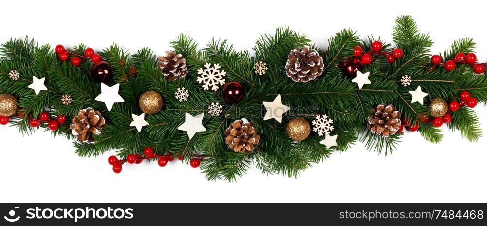 Christmas Border frame stripe of tree branches on white background with copy space isolated, red and golden decor, berries, stars, cones. Christmas frame of tree branches
