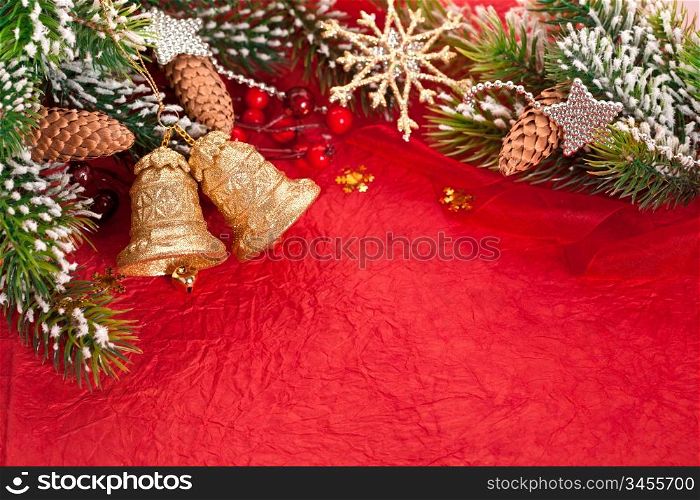 Christmas border from branch and decorations on red background