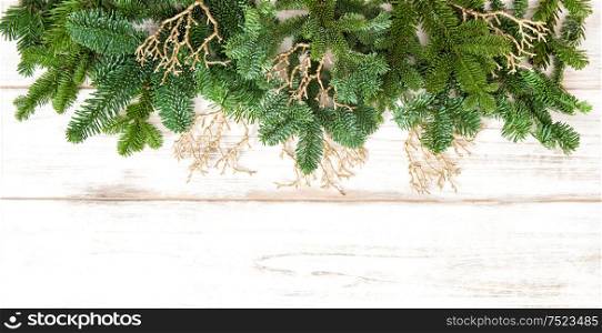 Christmas border with golden decorations on wooden background. Winter holidays